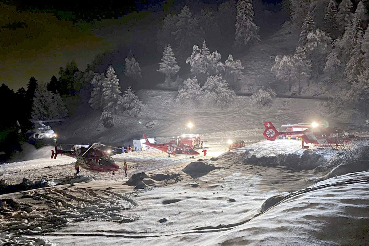 Mountain rescuers and helicopters participate in a rescue mission in the Swiss Alps, near Sion, Switzerland, Sunday, March 10, 2024.