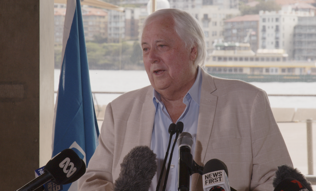 Clive Palmer in front of a podium.