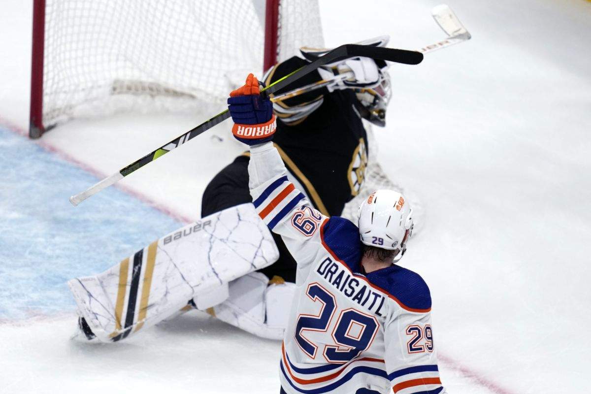 Edmonton Oilers centre Leon Draisaitl (29) raises his stick after his goal against Boston Bruins goaltender Linus Ullmark in overtime of an NHL hockey game Tuesday, March 5, 2024, in Boston. The Oilers won 2-1.