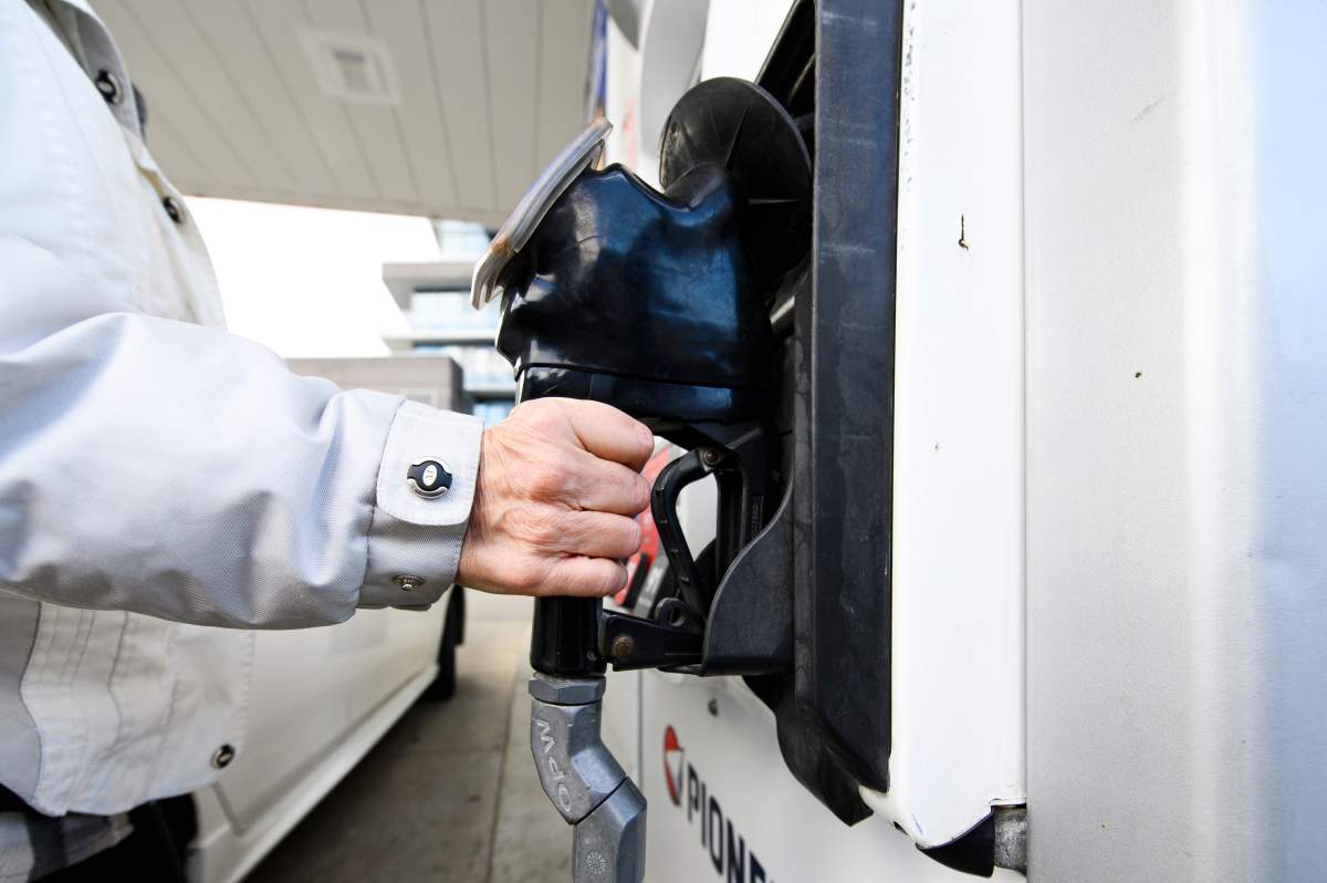 A woman gasses up at a gas station in Mississauga, Ont., Tuesday, February 13, 2024.