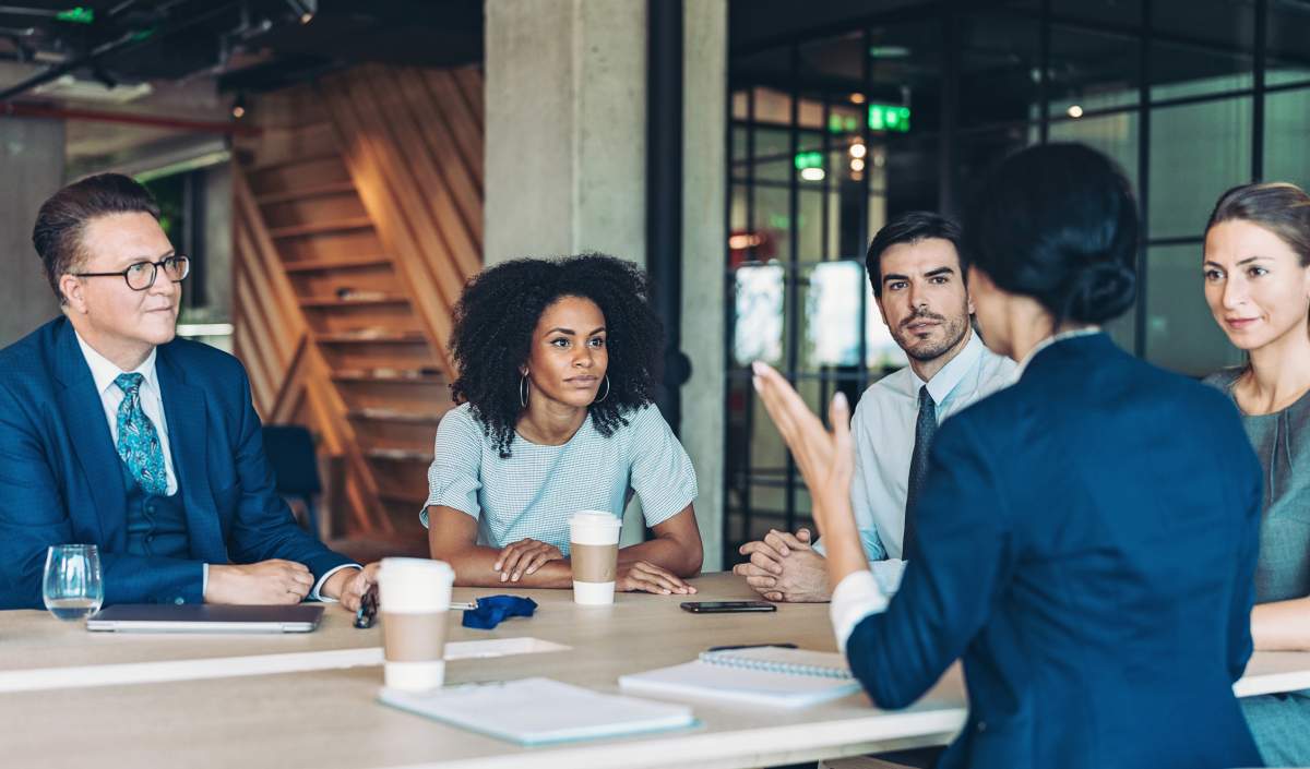 Multi-ethnic group of business persons discussing class action case