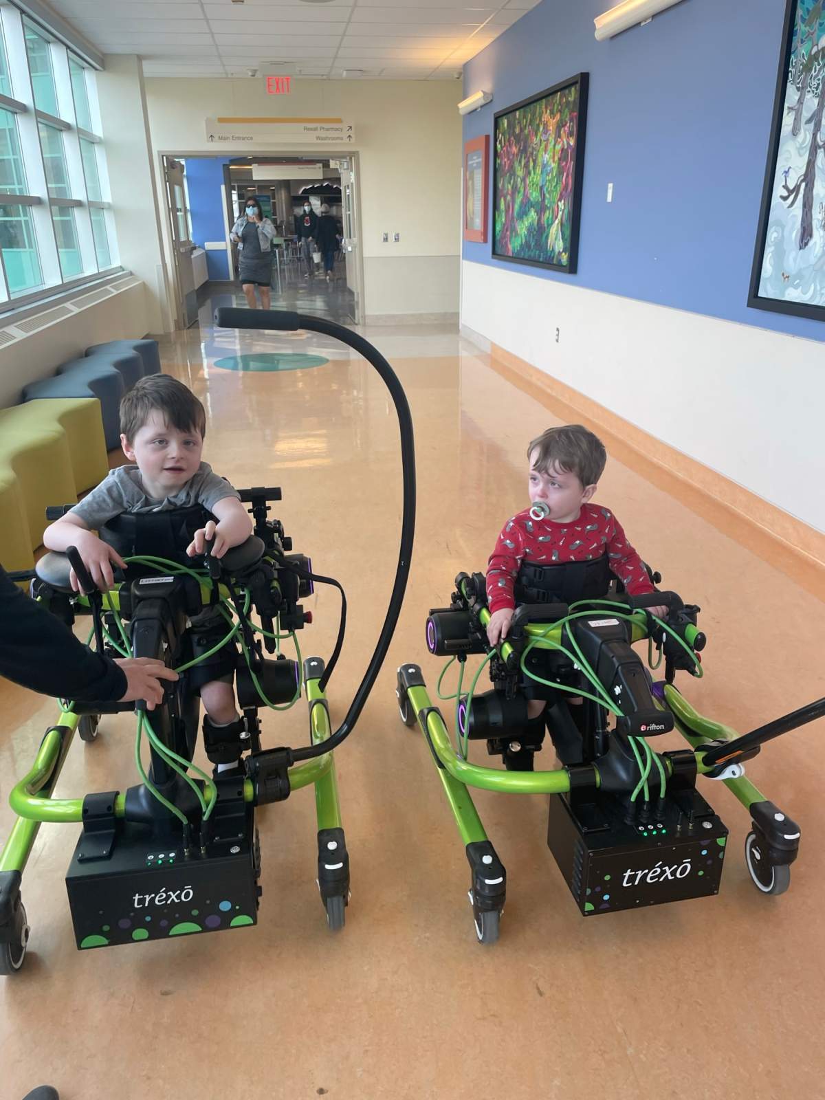 Jaxson and Joseph trying out the Trexo Walker at the Alberta Children’s Hospital