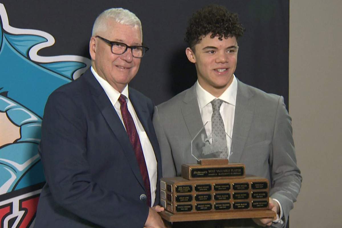 Kelowna Rockets president and GM Bruce Hamilton, left, hands out the team’s MVP award on Thursday to forward Tij Iginla.