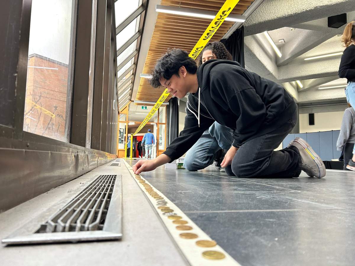 Students line loonies in the hallways of John Abbott College on March 13, 2024.