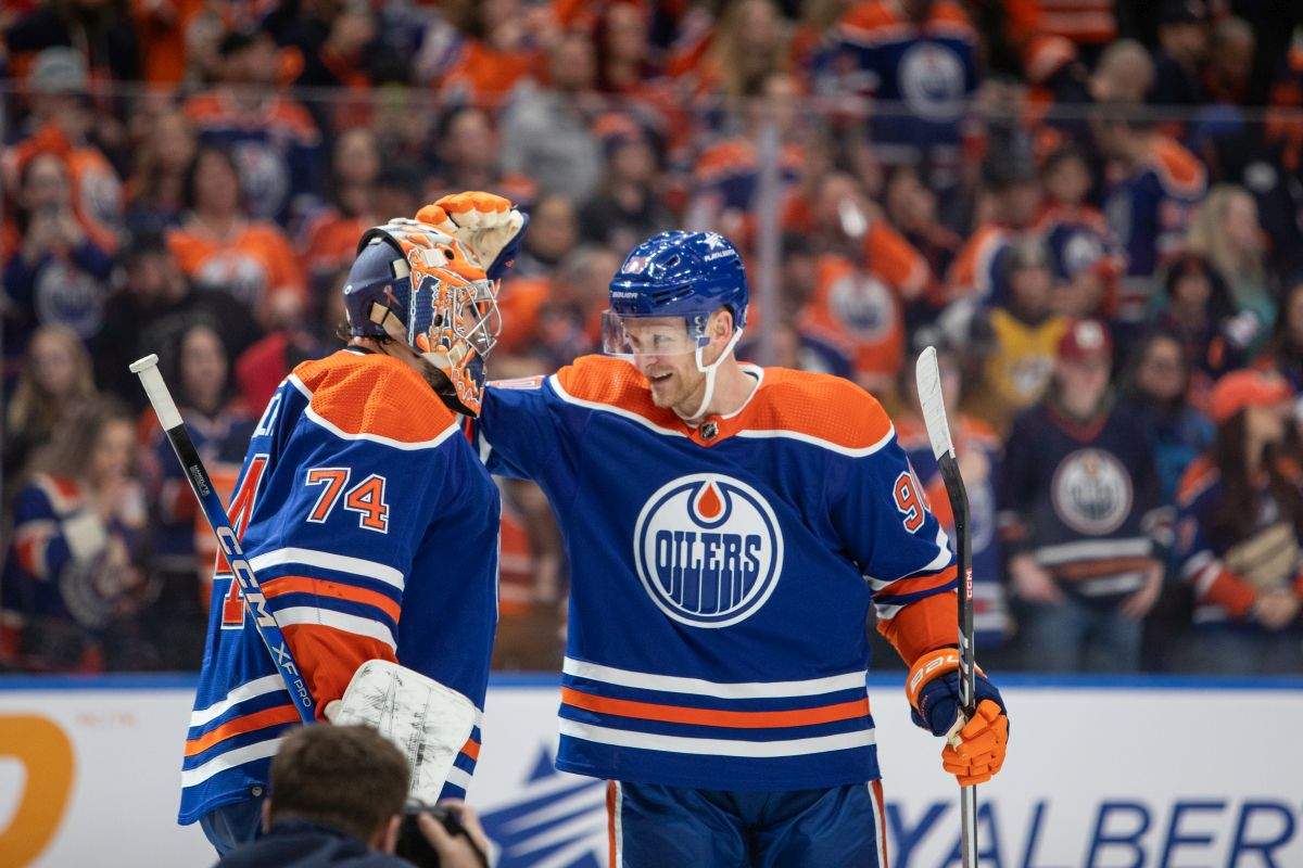 Edmonton Oilers' Corey Perry (90) congratulates goalie Stuart Skinner (74) after a win against the Nashville Predators in NHL hockey action in Edmonton, Saturday, Jan. 27, 2024.