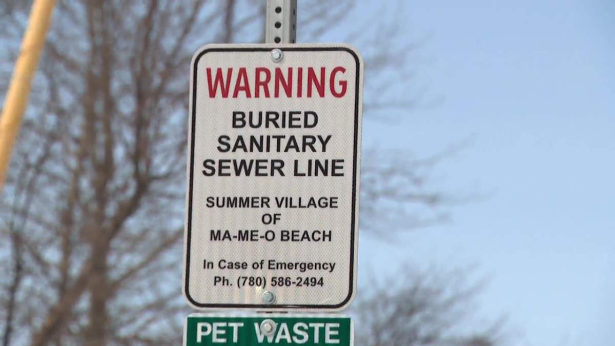 A buried sewer line sign in at the village of Ma-Me-O Beach in central Alberta on Tuesday, March 26, 2024.