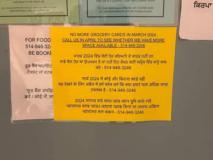 A multi-lingual sign at a Montreal food bank warns users that they can't give out that they can't take on any they are out of grocery cards for the month of March