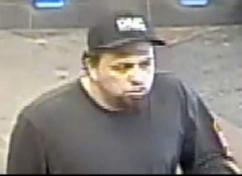 According to police, the suspect is described as male with a black goatee. He was wearing a dark baseball cap, dark grey sweater with an orange/red stripe on the left sleeve, light blue jeans, and dark brown shoes.