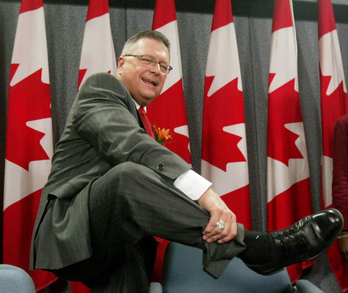 Finance Minister Ralph Goodale shows his new budget shoes at a news conference following his 2004 budget speech in Ottawa Tuesday March 23, 2004.