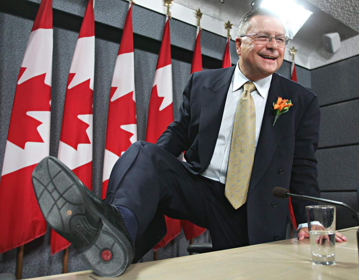 Finance Minister Ralph Goodale shows off his new shoes following a news conference in Ottawa. Wednesday, Feb. 23, 2005.