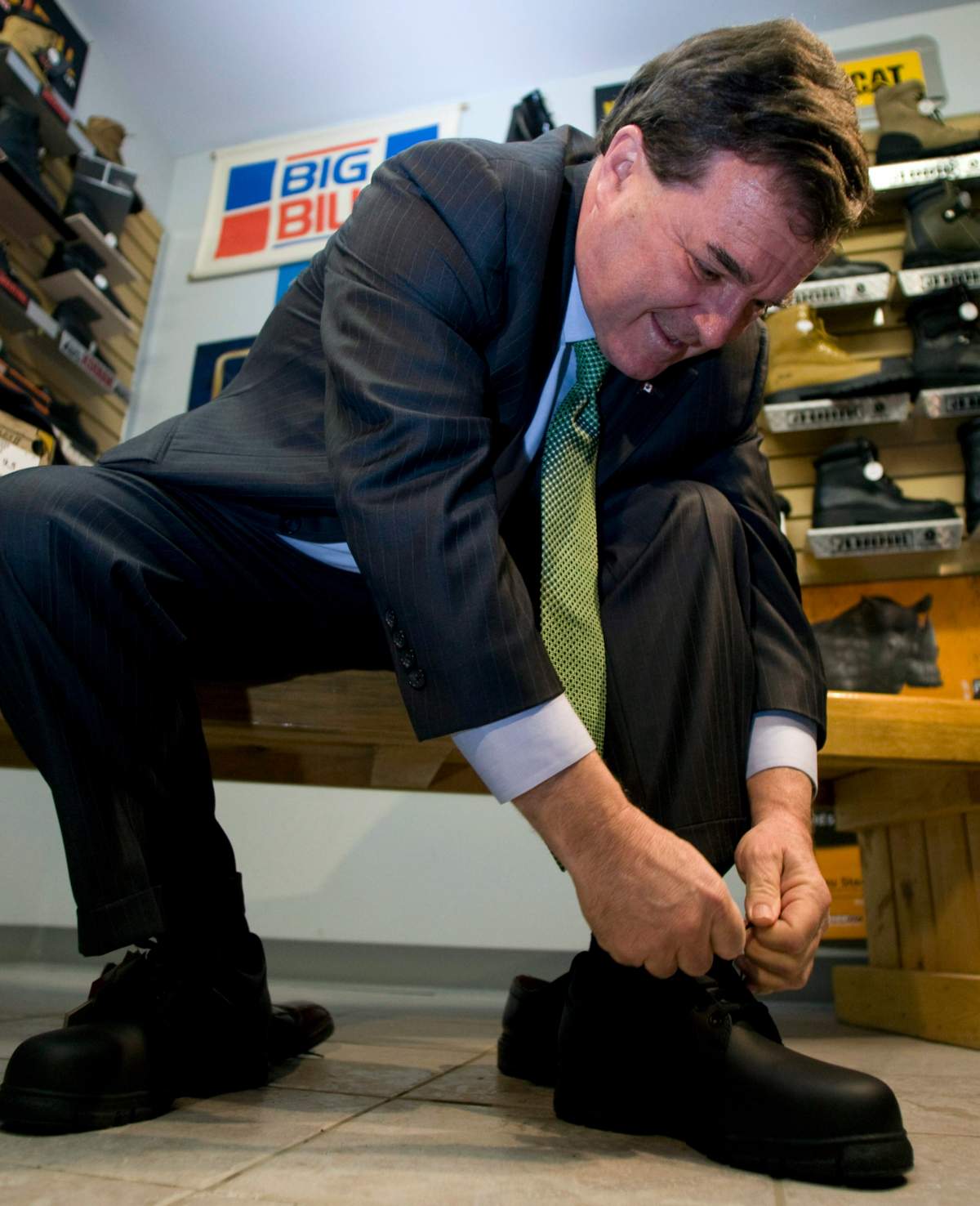 Finance Minister Jim Flaherty tries on a pair of shoes during a pre-budget photo op in Gatineau, Quebec Monday, Jan. 26, 2009.