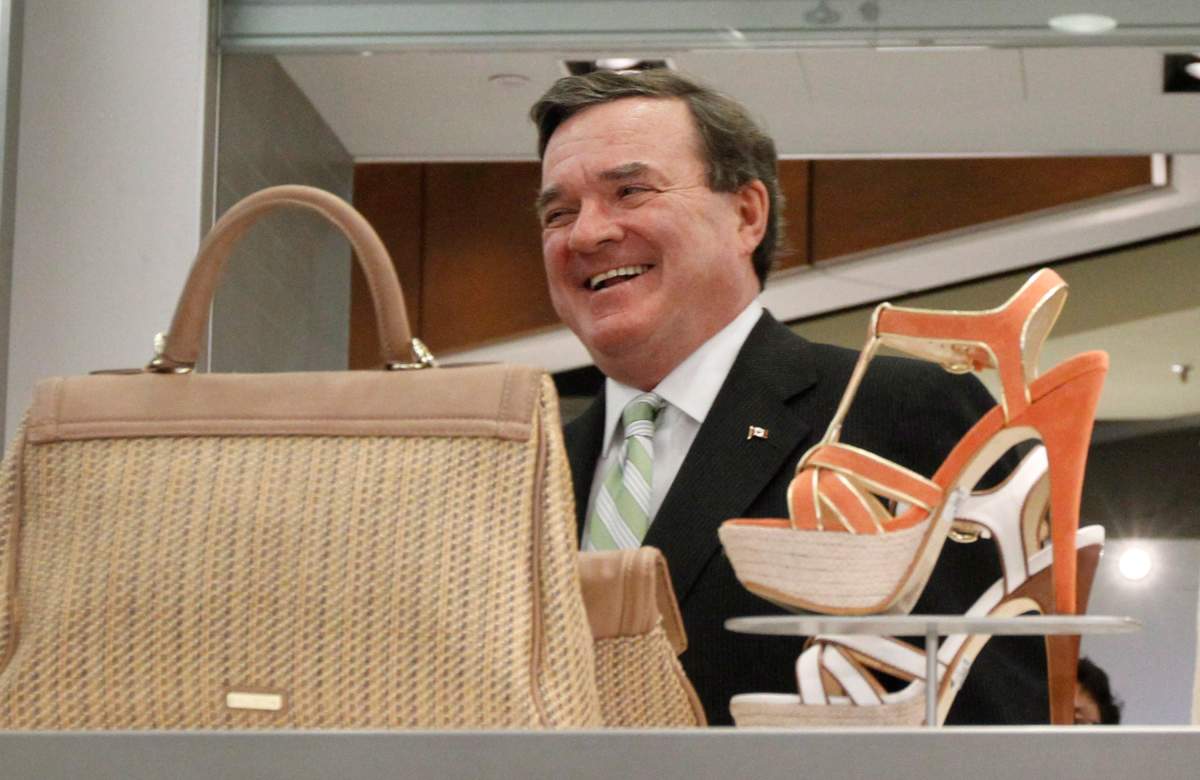 Finance Minister Jim Flaherty laughs has he walks by some women's shoes as he looks for a pair of new shoes for himself in advance of delivering the federal budget, in Ottawa, Wednesday, March 28, 2012.