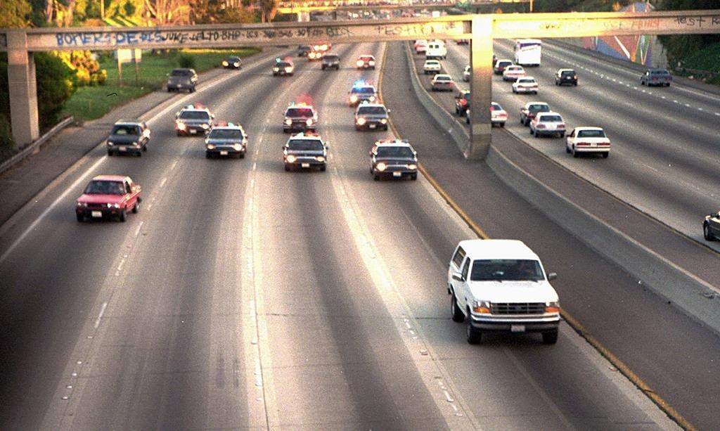 FILE - In this June 17, 1994 file photo, a white Ford Bronco, driven by Al Cowlings carrying O.J. Simpson, is trailed by Los Angeles police cars as it travels on a freeway in Los Angeles.