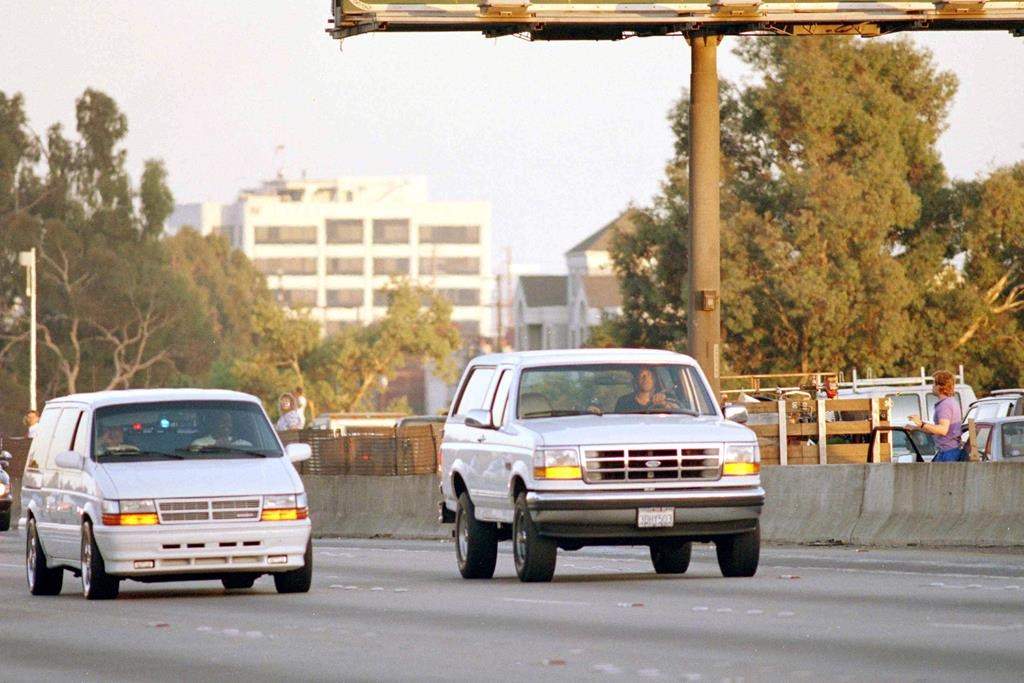 FILE - Al Cowlings, with O.J. Simpson hiding, drives a white Ford Bronco as they lead police on a two-county chase along the northbound 405 Freeway towards Simpson's home, June 17, 1994, in Los Angeles.