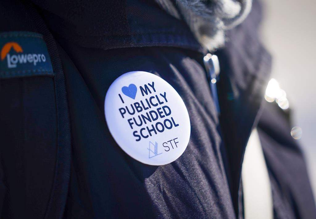 A person wears a Saskatchewan Teachers' Federation button during a provincewide, one-day strike organized by members of the Saskatchewan Teachers' Federation in Saskatoon on Tuesday, Jan. 16, 2024.