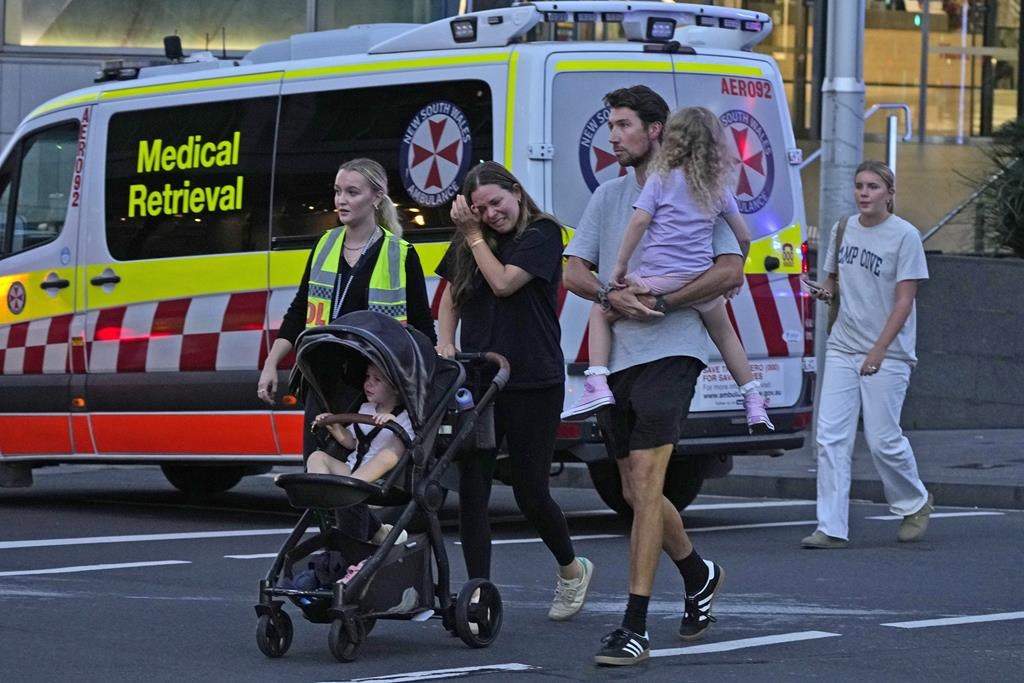 People are led out from the Westfield Shopping Centre where multiple people were stabbed in Sydney, Saturday, April 13, 2024. The Sydney Morning Herald reported that four people died in the stabbing.