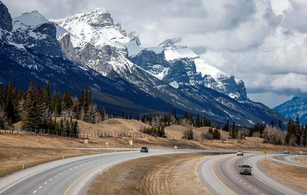Traffic travels along the Trans Canada Highway past Mount Rundle of the Rocky Mountains near Canmore, Alta., Monday, April 24, 2023. Documents released under Alberta Freedom of Information laws confirm the United Conservative government was talking with the coal industry for "years" about relaxing a policy that protected the Rocky Mountains from open-pit mines. 