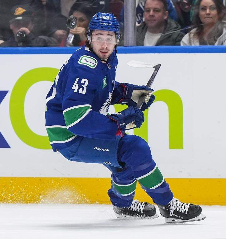 Vancouver Canucks' Quinn Hughes watches the puck as he skates during the first period of an NHL hockey game against the Calgary Flames in Vancouver, on Tuesday, April 16, 2024.