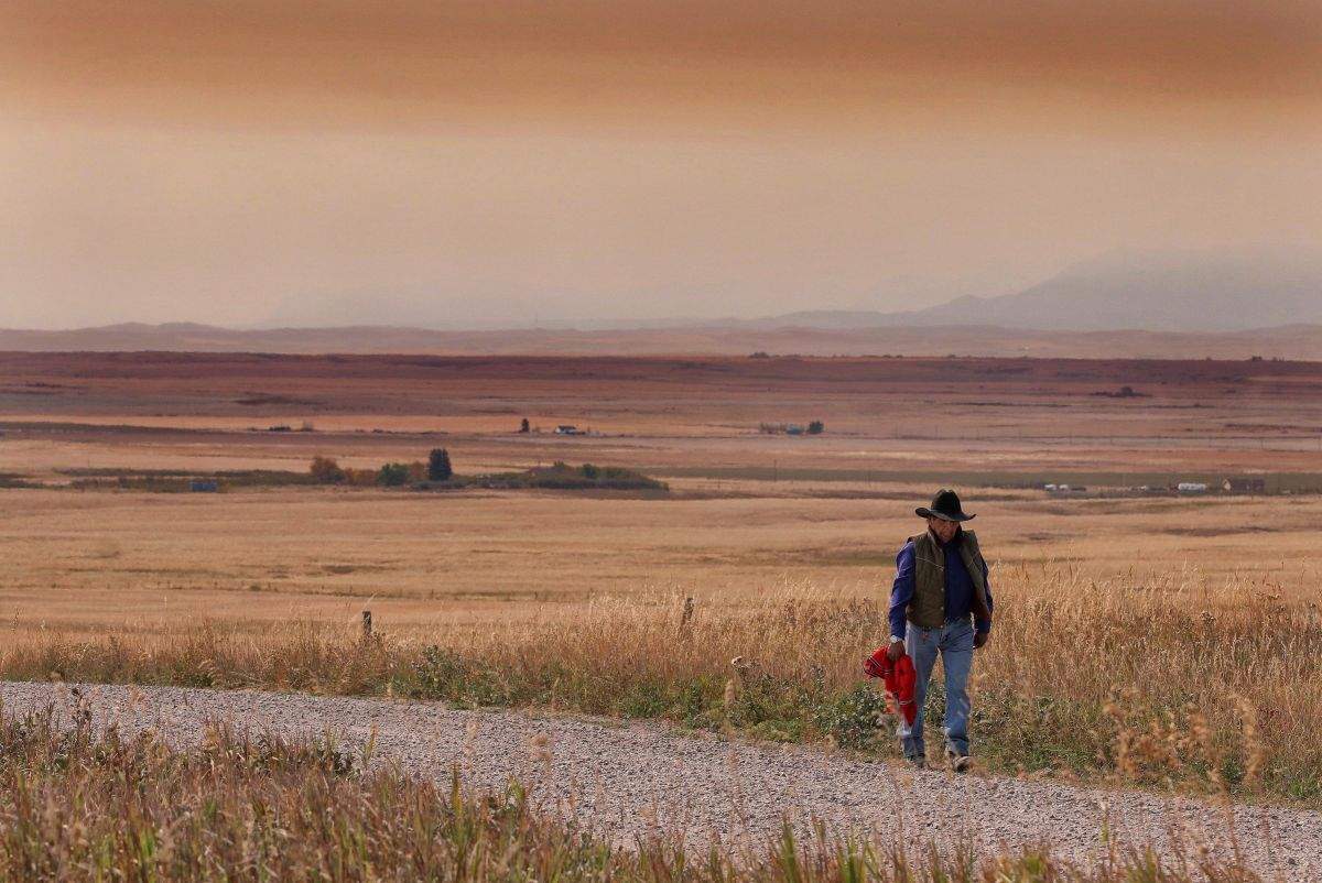 A resident of the Blood Reserve, southeast of Waterton Lakes National Park, Alta., walks down a side road on Tuesday, September 12, 2017.
