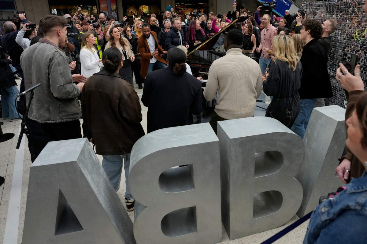 Members of the Mark de Lisser singers preform the iconic ABBA song ‘Waterloo’ at Waterloo Station in London, Saturday, April 6, 2024.