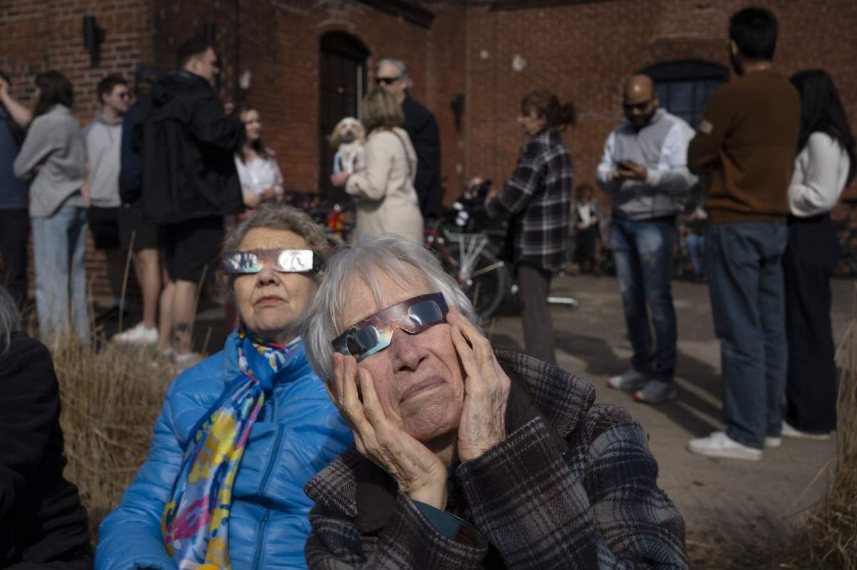 Skywatchers experience the total solar eclipse in Fredericton, Monday, April 8, 2024. THE CANADIAN PRESS/Darren Calabrese