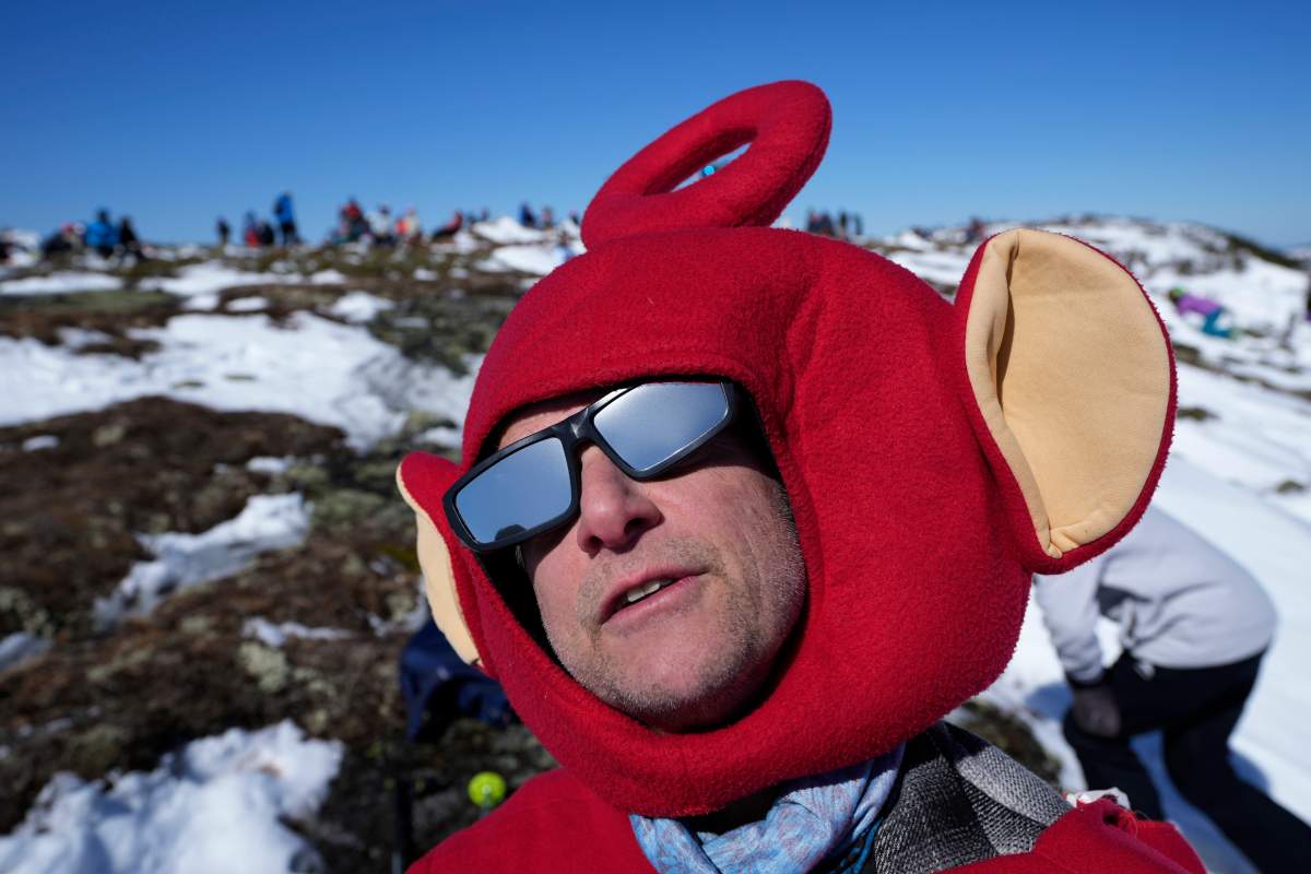 Chris Kuhn, of Yarmouth, Maine, wears a Teletubbies costume while watching the eclipse on the Appalachian Trail near the summit of Saddleback Mountain, Monday, April 8, 2024, near Rangeley, Maine. (AP Photo/Robert F. Bukaty)