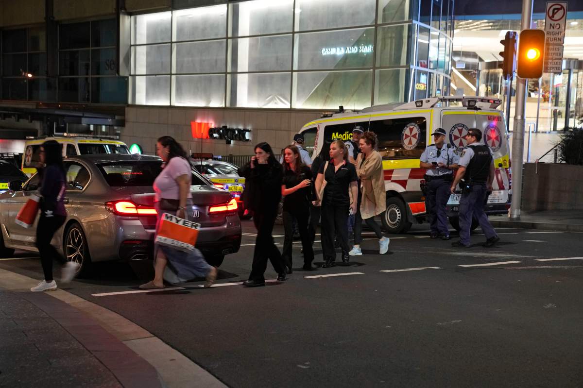 People are led out from the Westfield Shopping Centre where multiple people were stabbed in Sydney, Saturday, April 13, 2024.