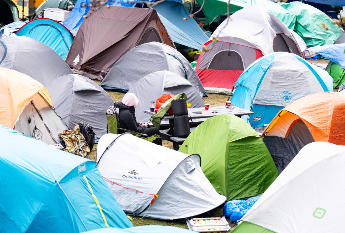 A pro-Palestinian activist is seen within an emcampment set up on the McGill University campus in Montreal, Monday, April 29, 2024.
