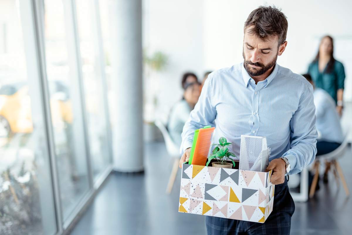 Male employee looking frustrated after loosing job. Business, firing and job loss concept
