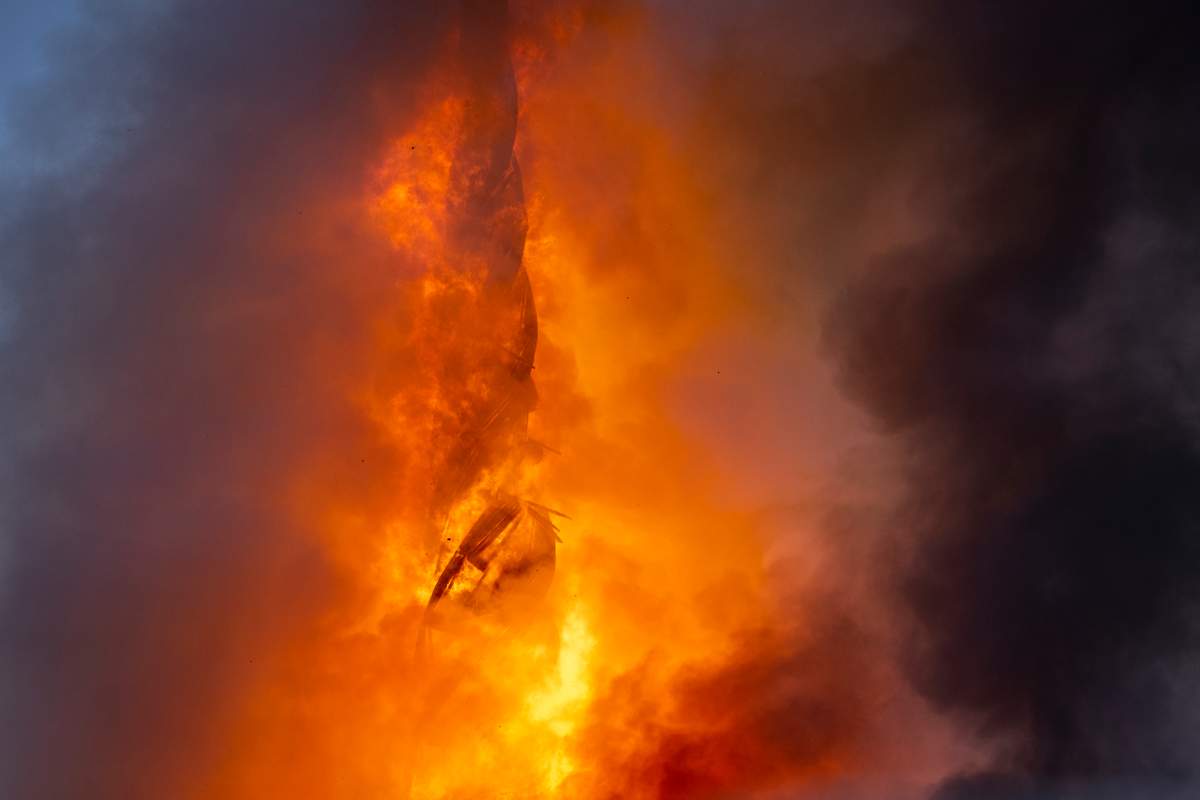 The spire, engulfed in flames.