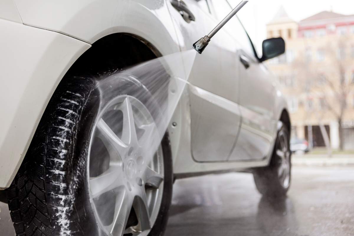 washing car outside with pressure washer