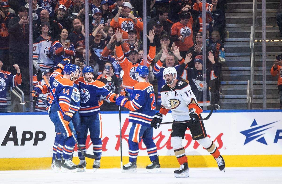 Anaheim Ducks' Alex Killorn (17) skates past as Edmonton Oilers' Mattias Ekholm (14), Adam Henrique (19) and Evan Bouchard (2) celebrate a goal during first period NHL action in Edmonton on Saturday March 30, 2024.