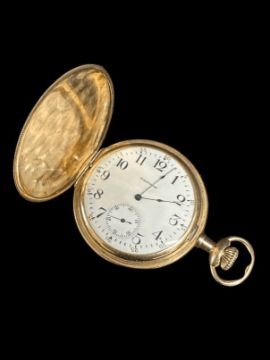 The inside clockface of a gold pocket watch. It reads 2:03.