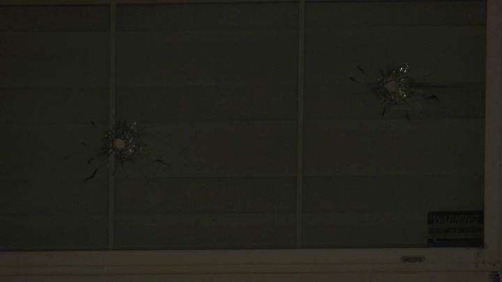 Bulletholes are seen in the window of a home in Calgary's Taradale neighbourhood on April 15, 2024.