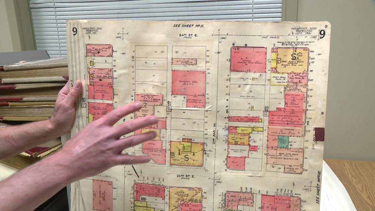 A fire insurance map being held at Saskatoon’s city archives.