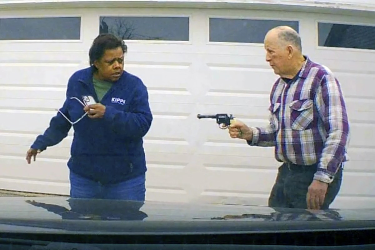 In this image taken from Uber dashcam video released by the Clark County, Ohio, Sheriff's Office, William Brock, right, holds a weapon to Uber driver Loletha Hall outside his home in South Charleston, Ohio, on March 25, 2024.