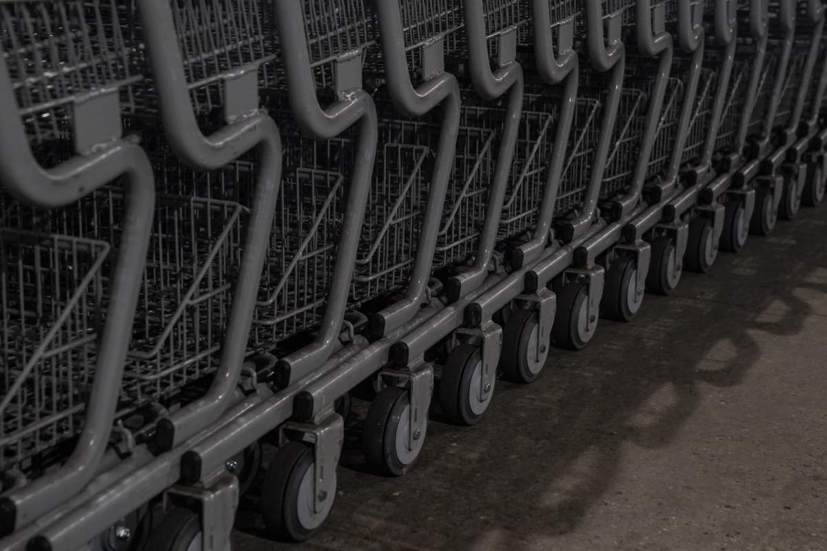 Grocery carts are lined up at a store.
