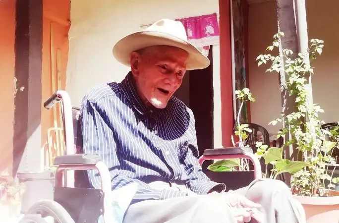 Juan Vicente Pérez sitting in a wheelchair at his home in Táchira, Venezuela.