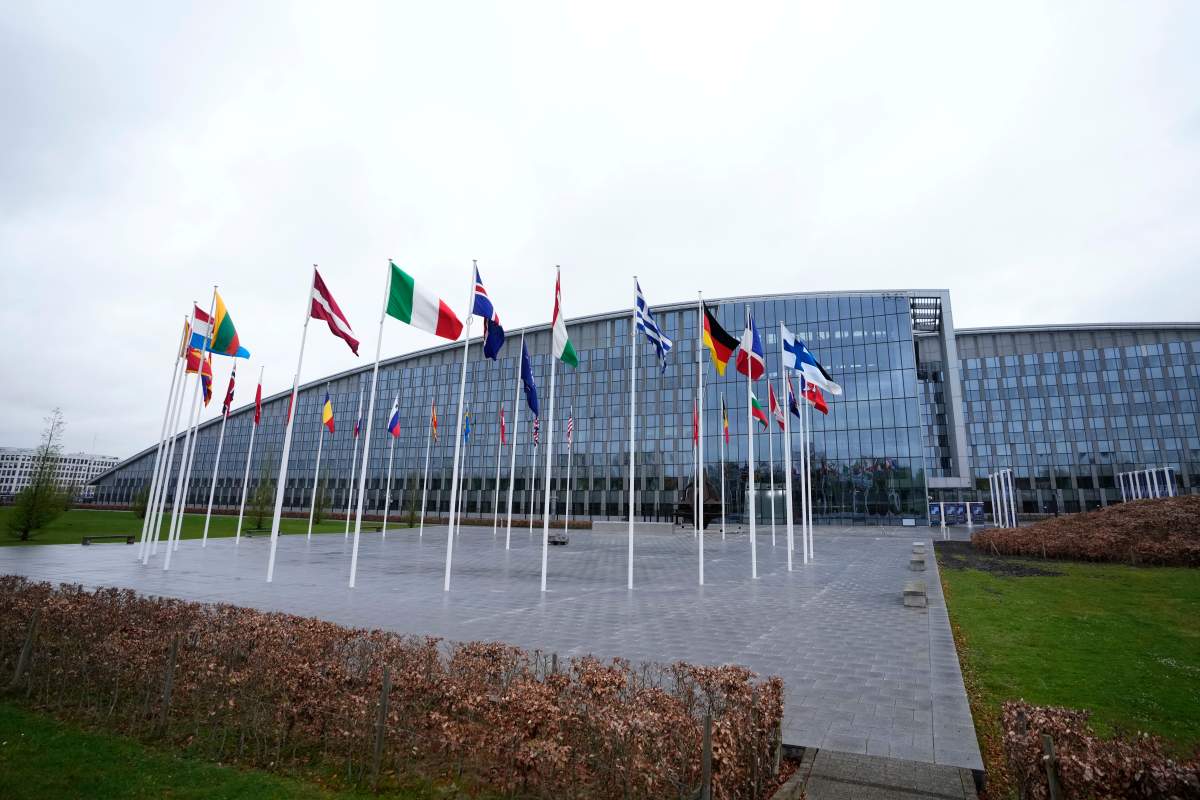Flags of NATO member countries flap in the wind outside NATO headquarters in Brussels, Wednesday, April 3, 2024.