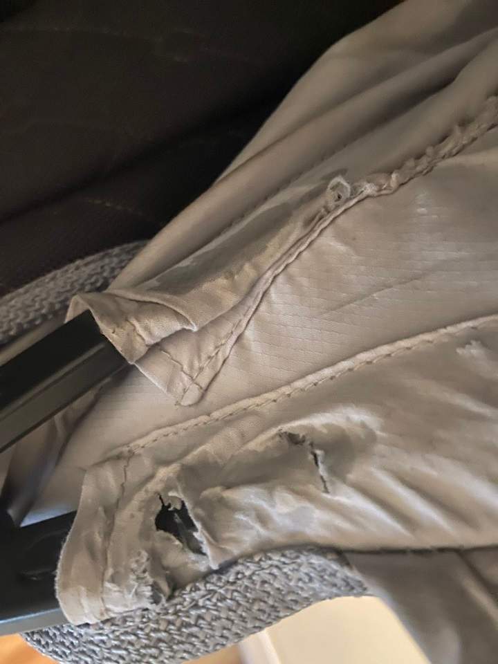 Rips and glue are seen in the stroller that Emma Austin bought online. It was advertised as near new.