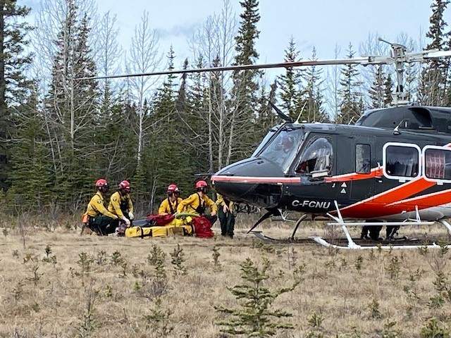 Wildland firefighting recruits learn how to safely get in and out of a helicopter.