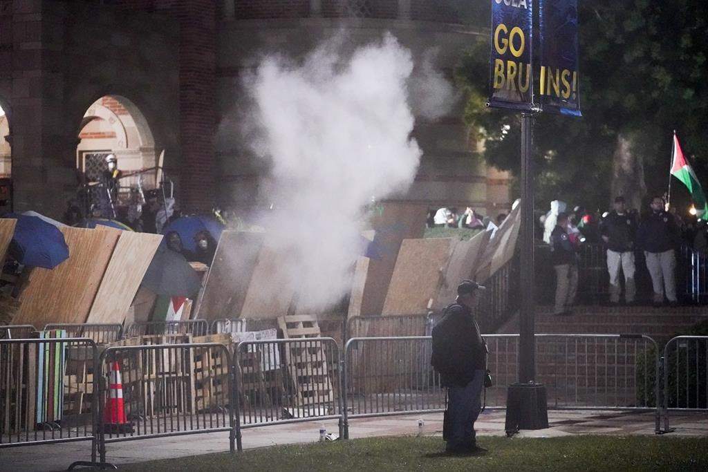 Pro-Palestinian demonstrators stand behind a barrier on the UCLA campus late Wednesday, May 1, 2024, in Los Angeles. (AP Photo/Ryan Sun)