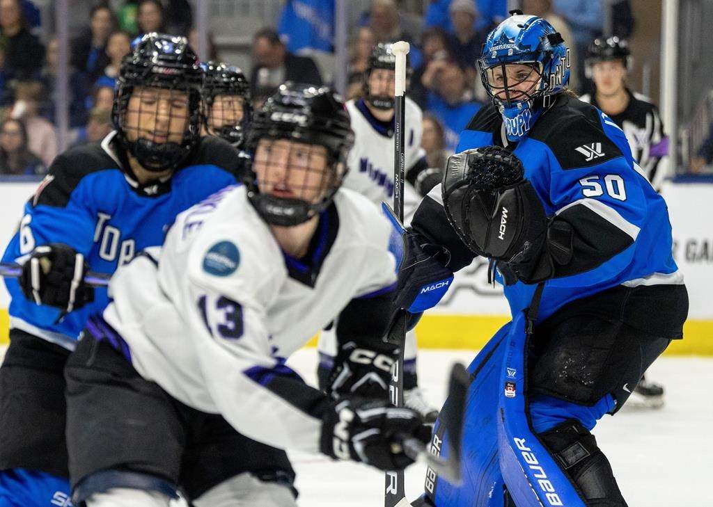 Toronto goaltender Kristen Campbell (50) keeps an eye on the play as Toronto’s Kali Flanagan (6) controls Minnesota’s Grace Zumwinkle (13) during second period PWHL playoff hockey action in Toronto on Wednesday, May 8, 2024.
