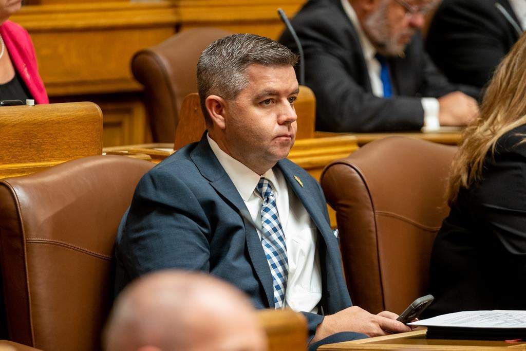 Saskatchewan Trade Minister Jeremy Harrison sits during the speech from the throne at the Saskatchewan legislature in Regina, on Wednesday, Oct. 26, 2022. A leaked document says Harrison nearly triggered a security incident in 2016 when he walked into the legislature wearing camouflage and carrying a long gun in a case. THE CANADIAN PRESS/Heywood Yu.