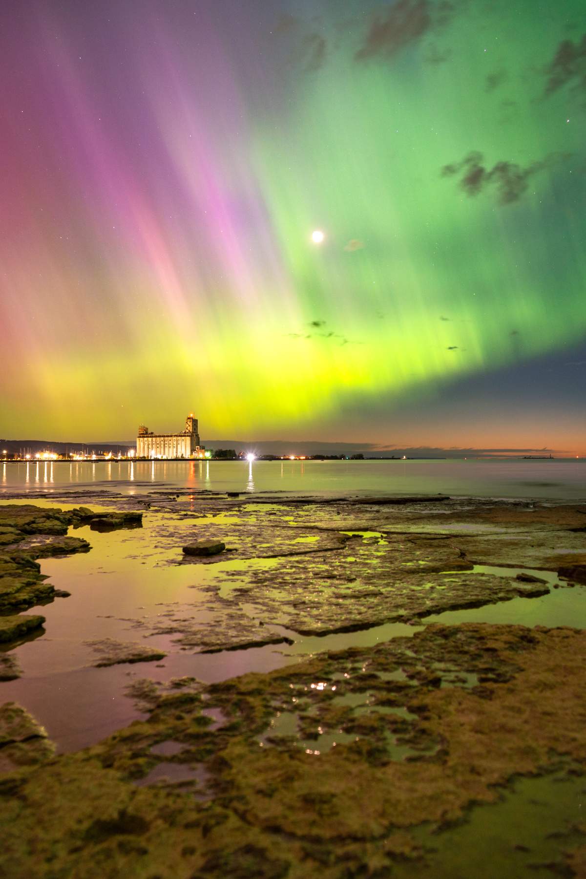 Pink and green northern lights at Sunset Point Beach in Collingwood, Ont. on the night of May 10, 2024