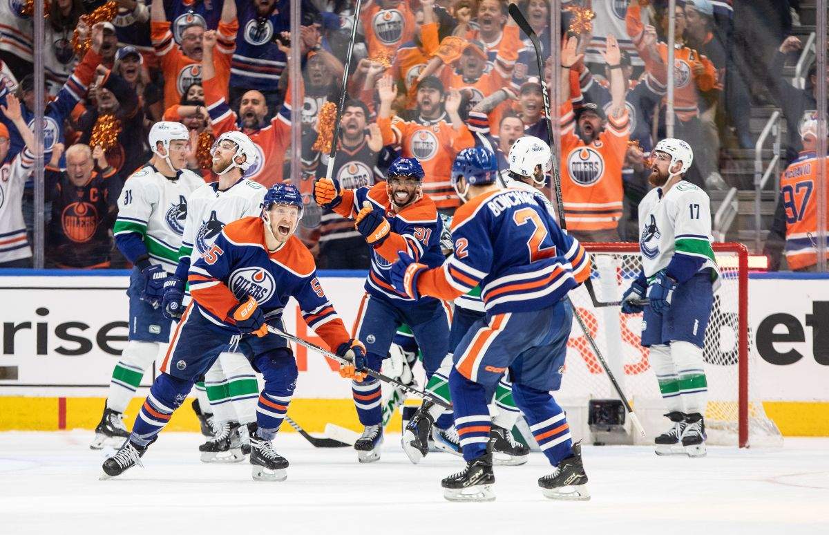 Edmonton Oilers' Evan Bouchard (2), Dylan Holloway (55) and Evander Kane (91) celebrate a goal against the Vancouver Canucks during third period second-round NHL playoff action in Edmonton on Tuesday May 14, 2024.