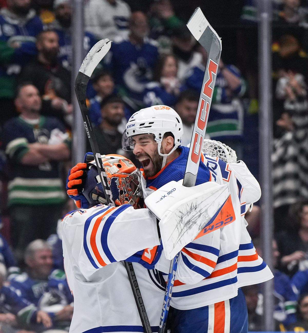 Edmonton Oilers' Evan Bouchard, right, and goalie Stuart Skinner celebrate after Edmonton defeated the Vancouver Canucks 3-2 during Game 7 of an NHL hockey Stanley Cup second-round playoff series, in Vancouver, on Monday, May 20, 2024.