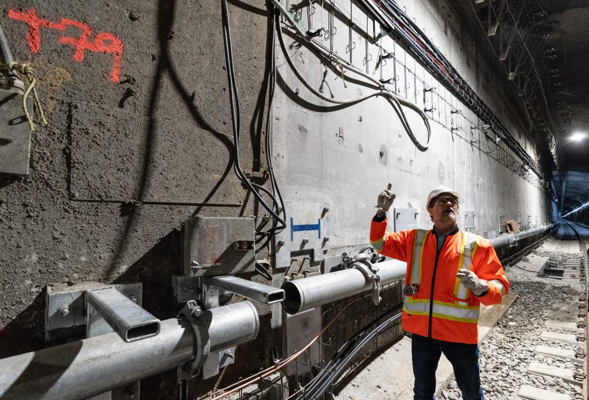 Mount Royal tunnel director Agustin Rey discusses the new walls during a media tour of the tunnel as construction progresses for the Reseau express metropolitain (REM) electric light rail system in Montreal, Wednesday, May 1, 2024. THE CANADIAN PRESS/Christinne Muschi