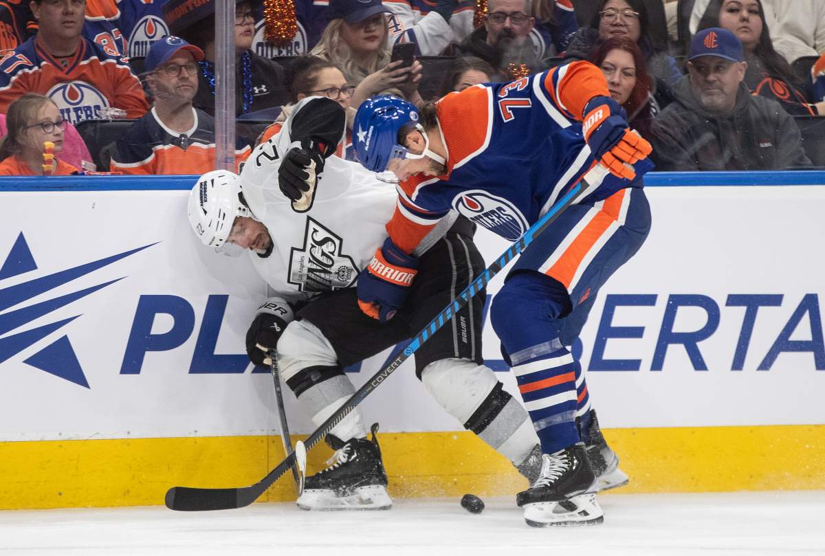 Los Angeles Kings' Kevin Fiala (22) and Edmonton Oilers' Vincent Desharnais (73) battle for the puck during first period NHL playoff action in Edmonton on Wednesday May 1, 2024.