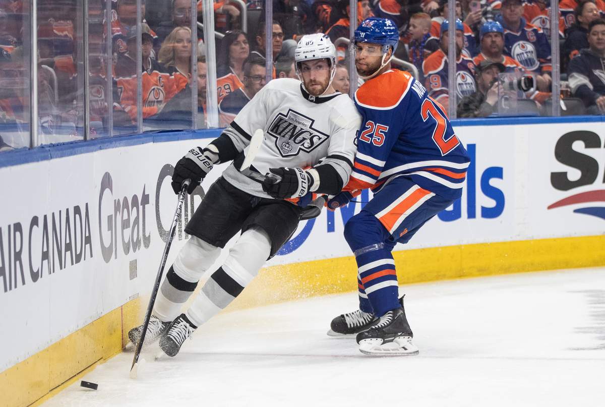 Los Angeles Kings' Pierre-Luc Dubois (80) and Edmonton Oilers' Darnell Nurse (25) battle for the puck during first period NHL playoff action in Edmonton on Wednesday May 1, 2024.